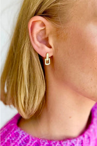 Behind The Trees - Close-up of a person wearing a gold hoop earring with a blurred background - Mosk.Melbourne - Raya Studs