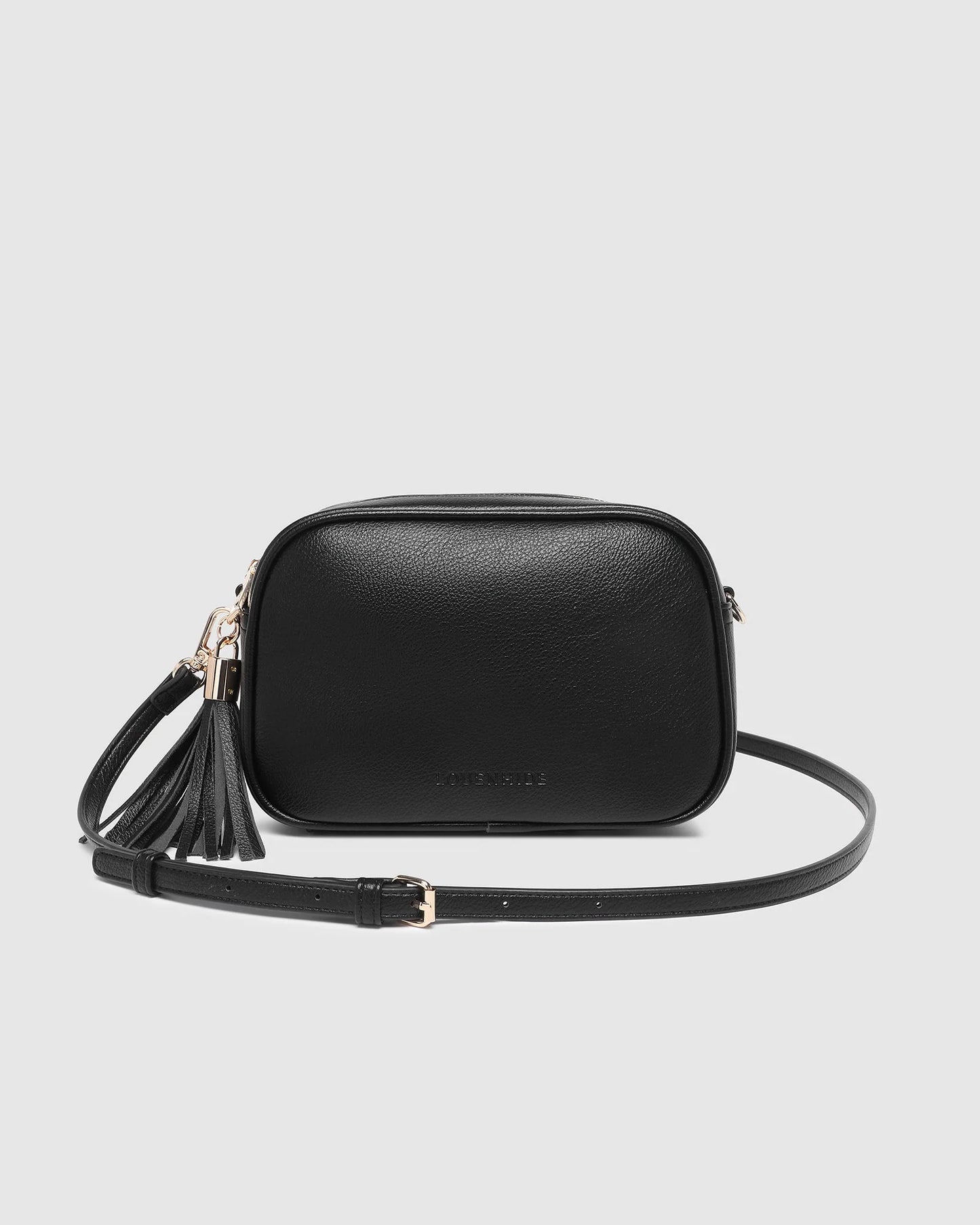 Behind The Trees - Black leather crossbody bag with a tassel on a light gray background - Louenhide - Jacinta Gia Crossbody Bag - Black