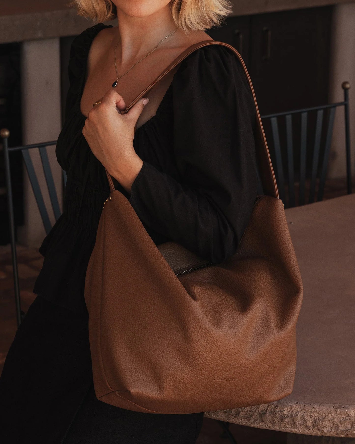 Behind The Trees - Brown leather handbag on a light gray background - Louenhide - Morgan Shoulder Bag - Caramel