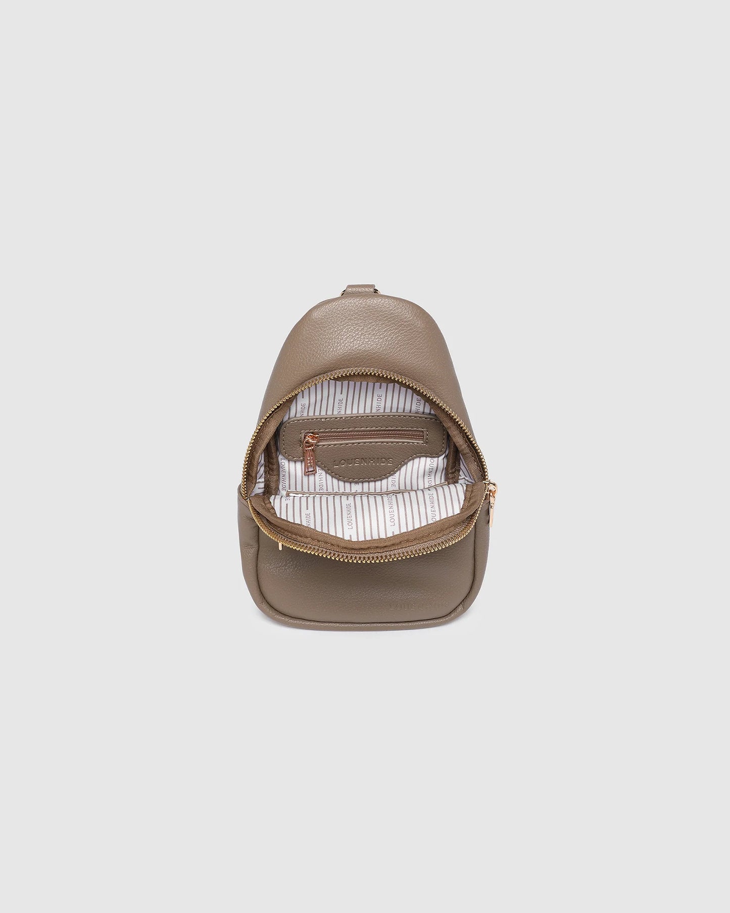 Behind The Trees - Beige leather sling bag on a light gray background - Louenhide - Baby Bella Sling Bag - Mocha