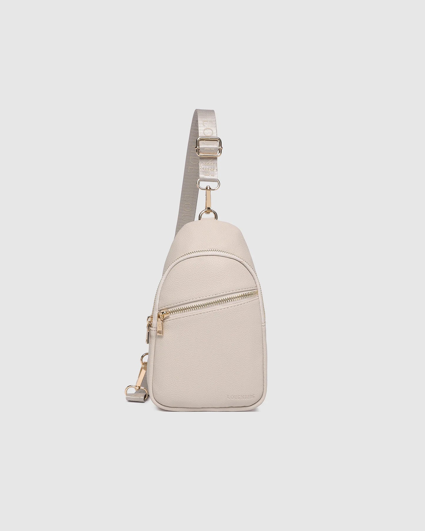 Behind The Trees - Beige crossbody bag on a light gray background - Louenhide - Baby Bella Sling Bag - Oat