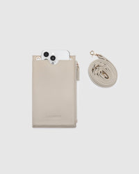 Behind The Trees - Beige phone case with strap and phone on a light gray background - Louenhide - Suki Phone Bag - Almond