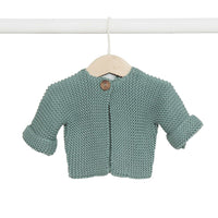 Behind The Trees - Knitted baby sweater with a button on a hanger against a white background - DLUX - Baby Elf Knitted Cardigan - Sage