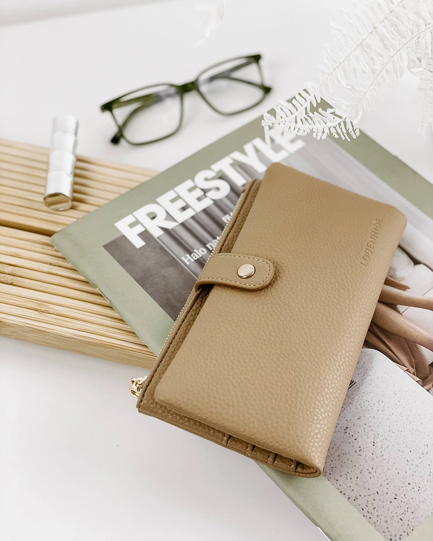 Behind The Trees - Tan wallet with a gold zipper and brand logo on a light gray background - Louenhide - Stella Wallet - Latte