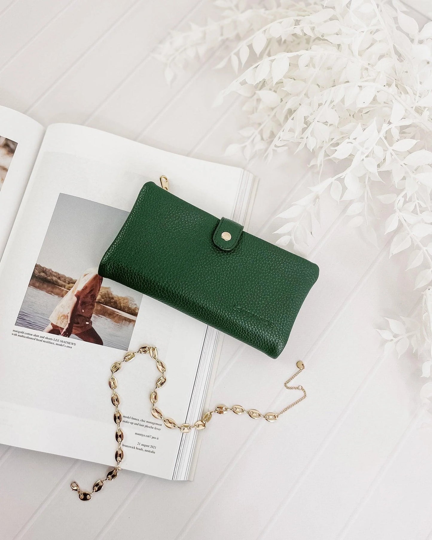 Behind The Trees - Green wallet with a gold zipper on a light gray background - Louenhide - Stella Wallet - Green