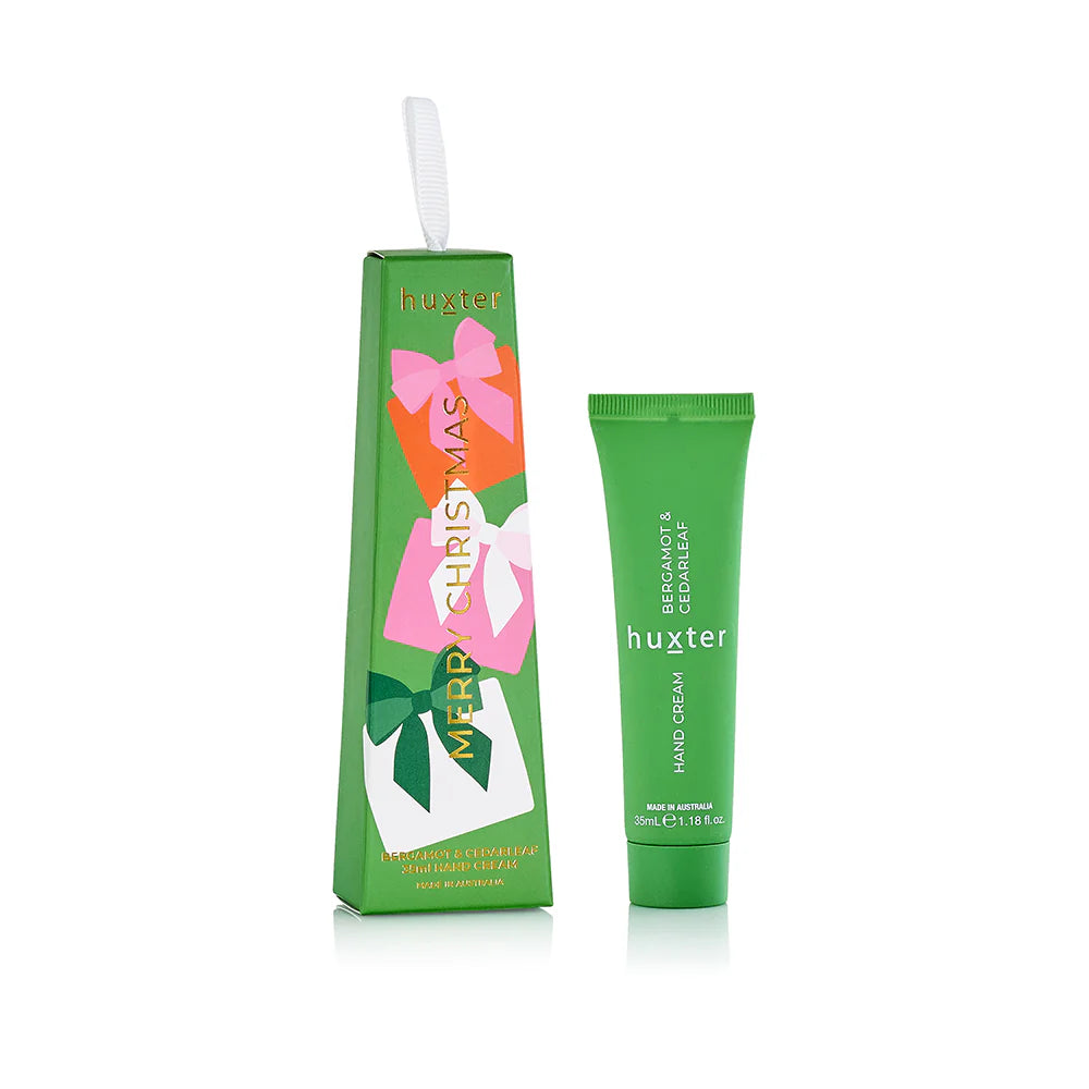 Behind The Trees - Green hand cream with floral design packaging on a white background - Huxter - Hanging Hand Cream 35ml - Bergamot & Cedarleaf