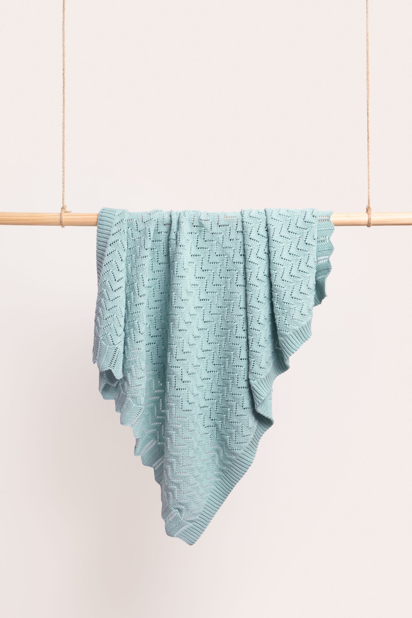 Behind The Trees - Light blue textured blanket draped over a wooden rod against a light background - DLUX - Mica Chevron Pointelle Knit Baby Blanket - Duck Egg