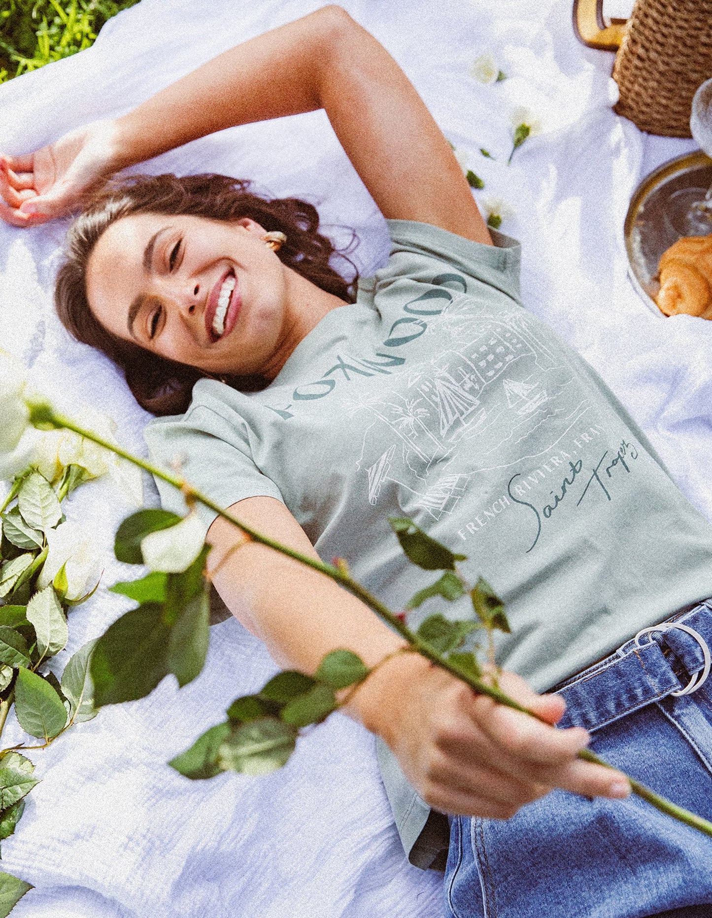 Behind The Trees - Woman wearing a green t-shirt with 'FOXWOOD' printed on it against a light gray background - Foxwood - French Riveria Tee - Iceburg Green