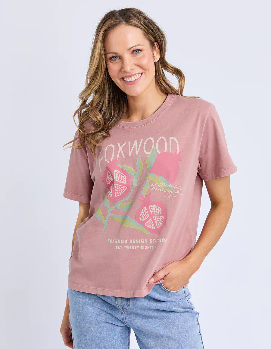 Behind The Trees - Woman wearing a pink t-shirt with a graphic design on a light gray background - Foxwood - Pomegrante Tee - Ash Rose 