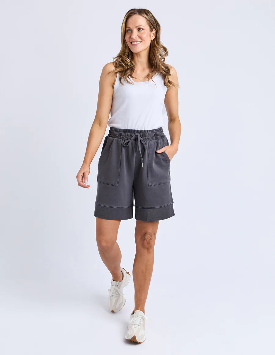 Behind The Trees - Woman wearing gray shorts and a white tank top on a white background - Foxwood - Hustler Short - Charcoal