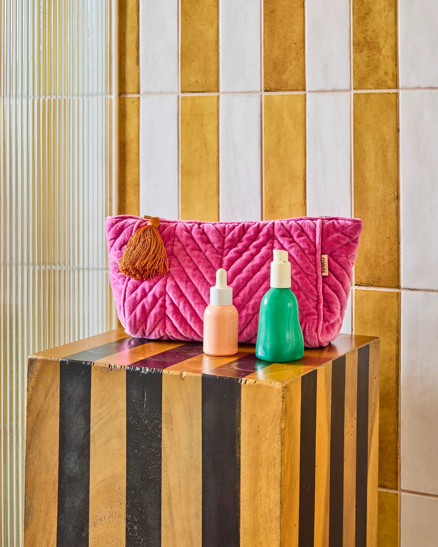 Behind The Trees - Pink quilted pouch with a tassel on a white background - Kip & Co - Velvet Toiletry Bag - Pink