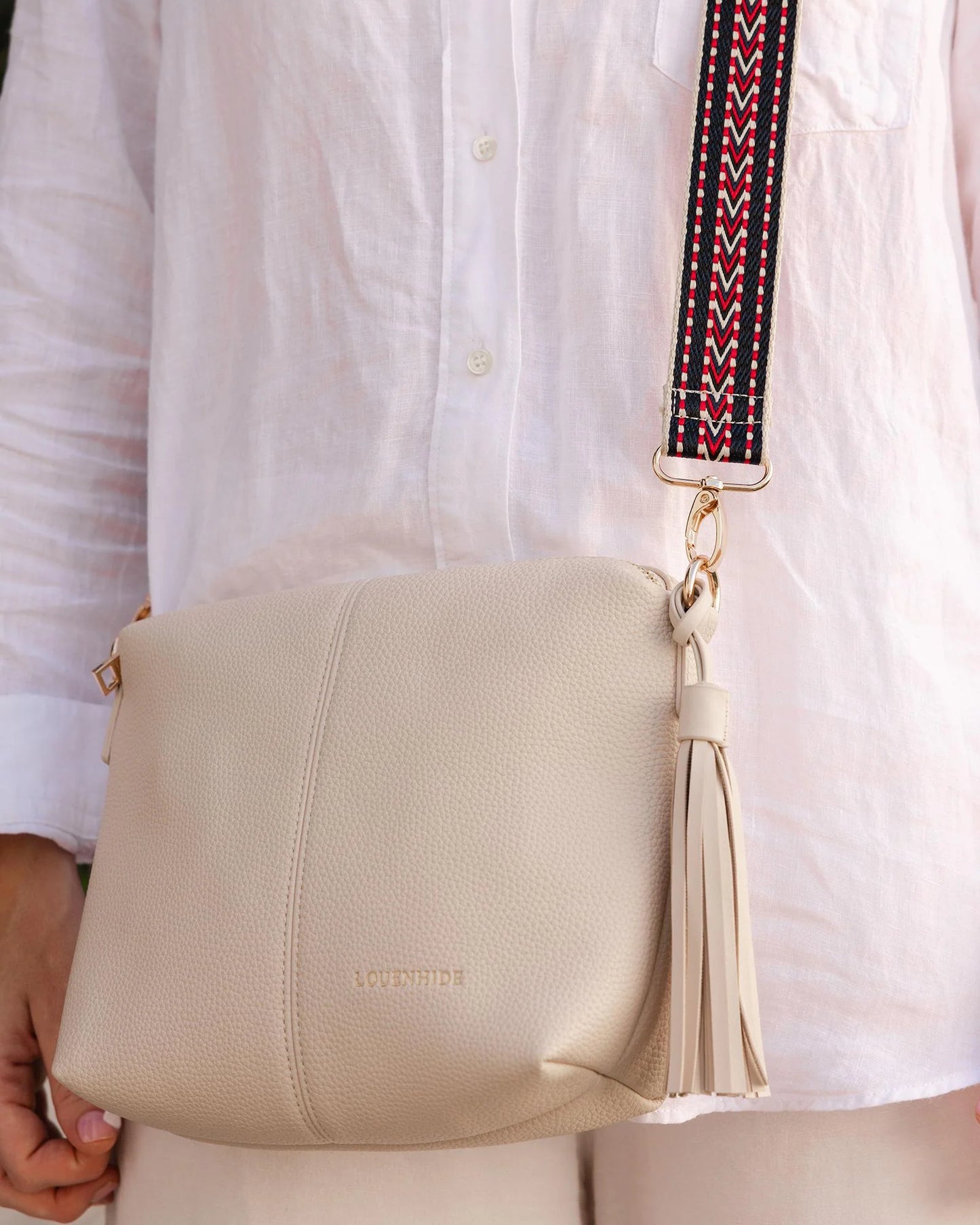Behind The Trees - Louenhide - Kasey Crossbody Bag - LinenBeige handbag with a patterned strap on a light gray background