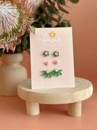 Behind The Trees - Set of earrings on a 'foxie' branded card with flowers and a vase in the background - Foxie Collective - Stud Pack trio - Green & Pink