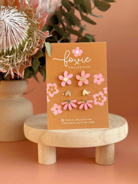 Behind The Trees - Card with floral earrings on a wooden stand against an orange background - Foxie Collective - Stud Pack trio - Candy Pink & Gold