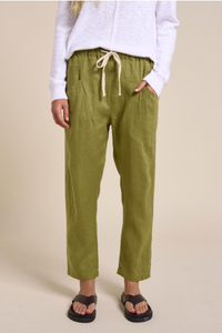 Behind The Trees - Person wearing green pants with a beige background - Little Lies - Luxe Linen Pants - Olive Green