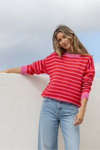 Behind The Trees - Woman wearing a red and pink striped sweater and light blue jeans against a neutral background - Miss Marlow - Zara Strip Knit - Red/Pink
