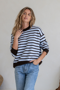 Behind The Trees - Woman wearing a black and white striped sweater with blue jeans against a neutral background - Miss Marlow - Zara Strip Knit - Blue/Chocolate