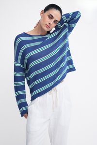 Behind The Trees - A woman modeling a loose, long-sleeve knit top with diagonal navy blue and mint green stripes, paired with white drawstring pants, against a plain white studio background. - Little Lies - Stripe Spring Knit - Stripe