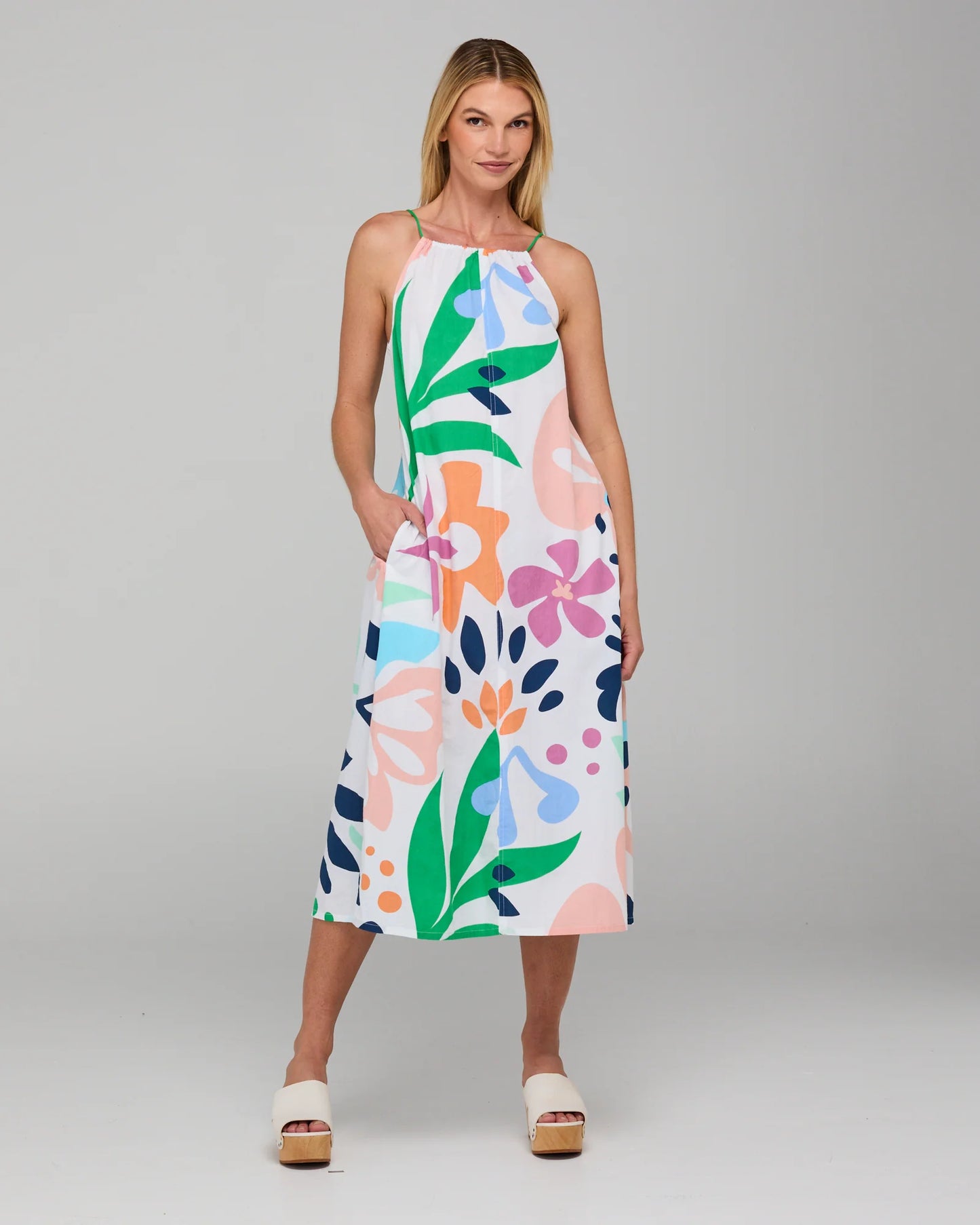 Behind The Trees - Woman wearing a colorful floral dress on a gray background - Boom Shankar - Aria Dress - Sorrento
