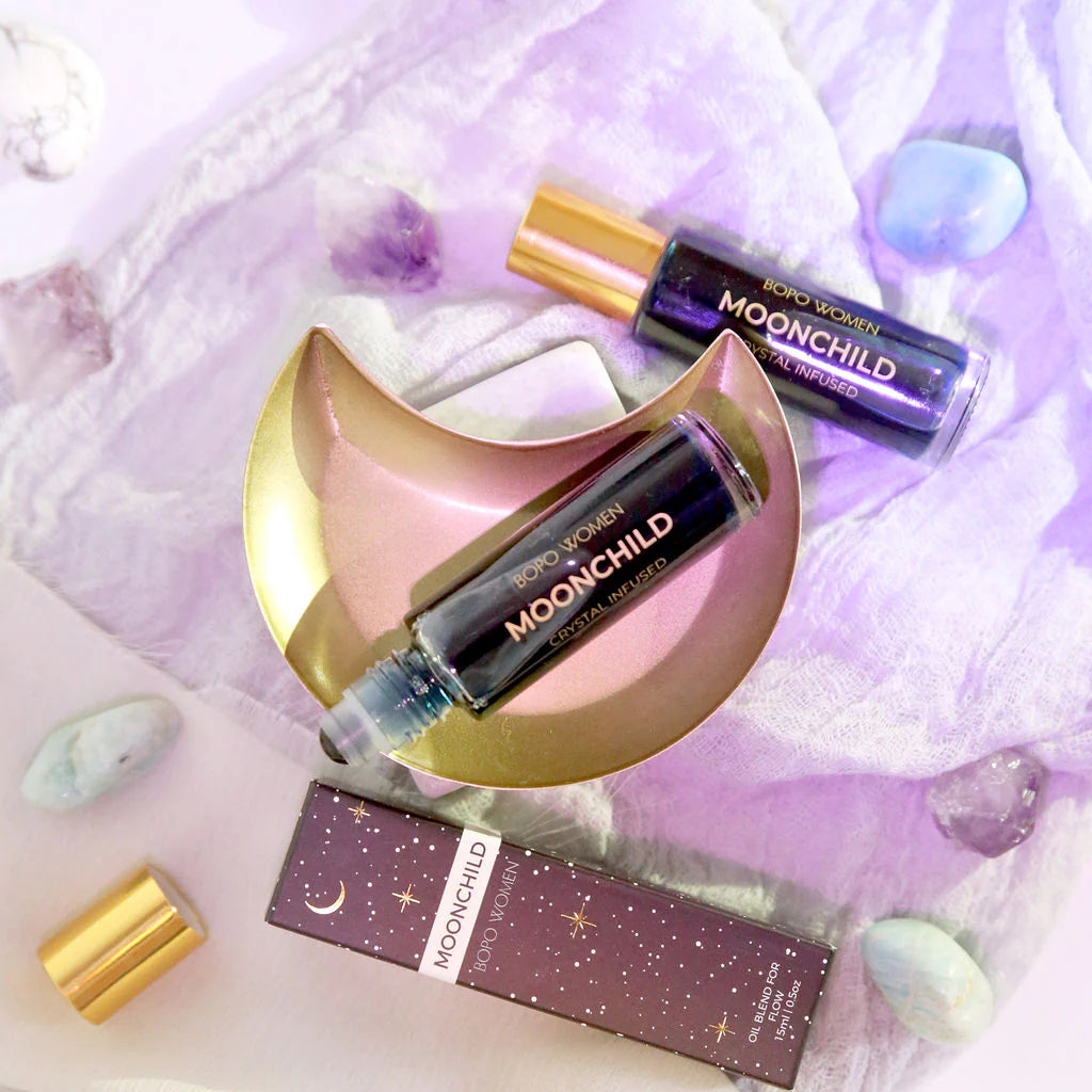 Behind The Trees - A crystal perfume roller named 'Moonchild' with a blue rollerball and black packaging featuring gold stars and moon designs - BOPO Women - Crystal Perfume Roller - Moonchild