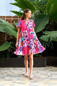 Behind The Trees - Woman wearing a colorful dress standing outdoors with greenery in the background - Boho Australia - Welch Dress - Floral Patch