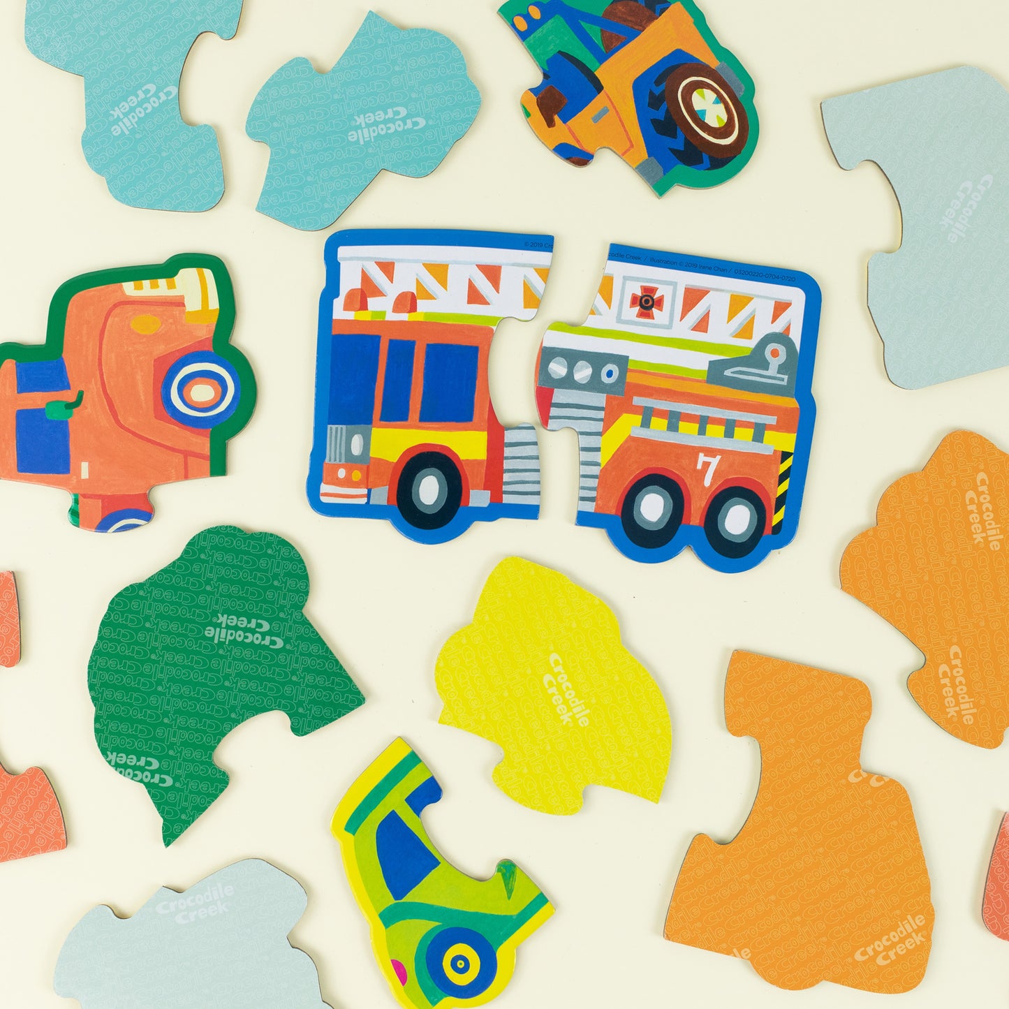 Behind The Trees - Child playing with colorful cards on a light-colored floor - Crocodile Creek - Let's Begin Puzzle 2 pc - Vehicles