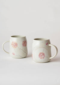 Behind The Trees - Two ceramic mugs with a glossy off-white finish, decorated with pink and red floral designs and delicate gray leafy stems, set against a plain light gray background. - Angus & Celeste - Everyday Mugs Two Set - Hakea