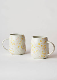 Behind The Trees - Two white ceramic mugs with yellow floral patterns, displayed on a light gray background. - Angus & Celeste - Everyday Mugs Two Set - Wattle