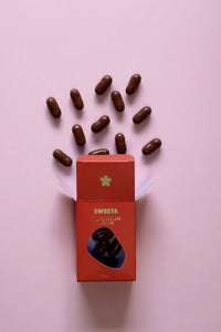 Behind The Trees - Red box labeled 'SWEETA' with chocolate candies on a pink background - Sweeta - Milk Chocolate Licorice 100g