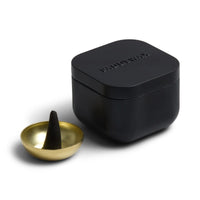 Behind The Trees - Black container with a gold bowl and black cone on a white background - Designworks Collective - Teak & Tobacco Incense - Black