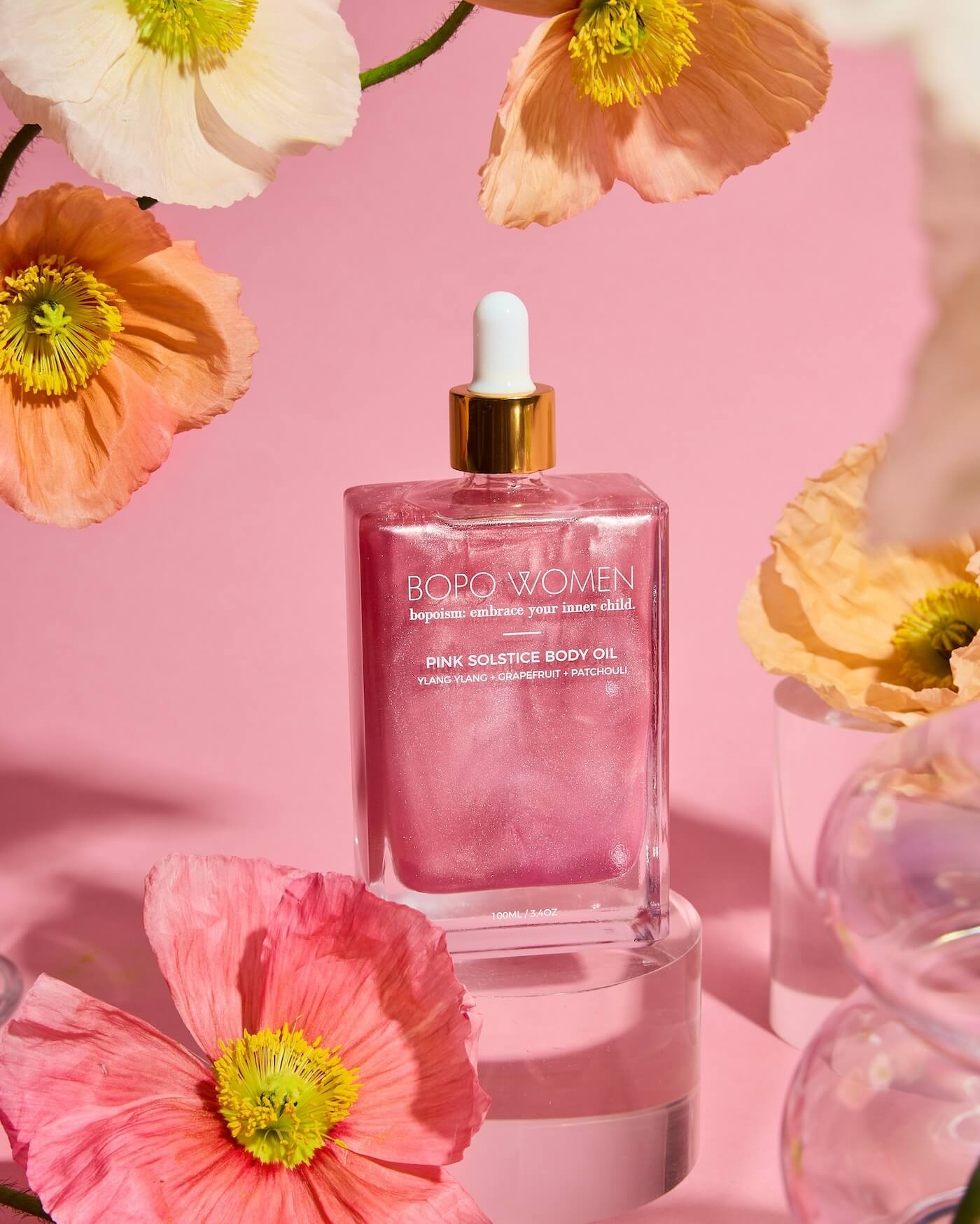 Behind The Trees - A pink bottle of BOPO Women body oil with a gold cap. The label reads 'Summer Solstice Body Oil' - BOPO Women - Body Oil - Summer Solstice - Pink