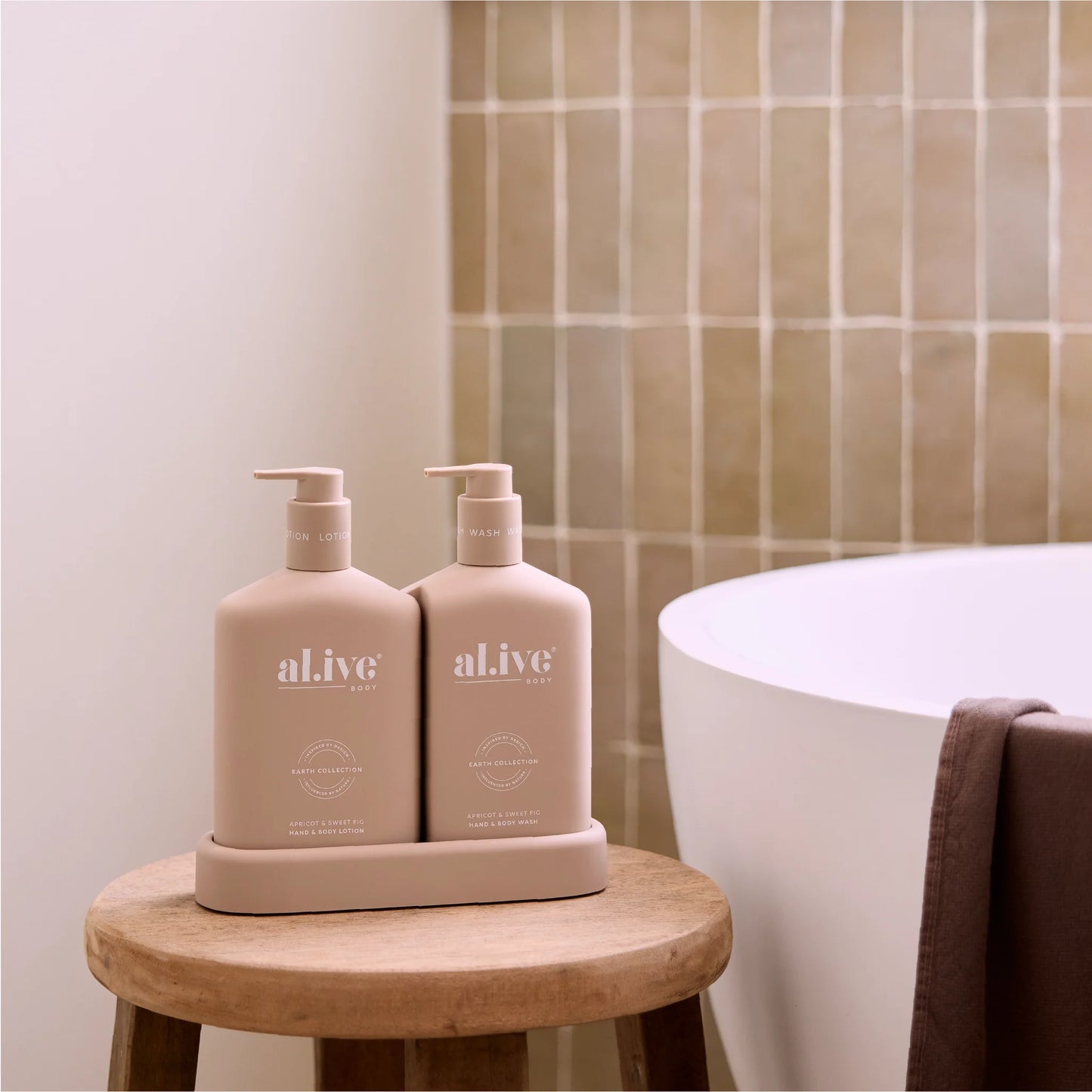 Behind The Trees - Two beige bottles with pump dispensers and a box labeled 'al.ive' on a white background. - al.ive - Wash & Lotion Duo - Apricot & Sweet Fig