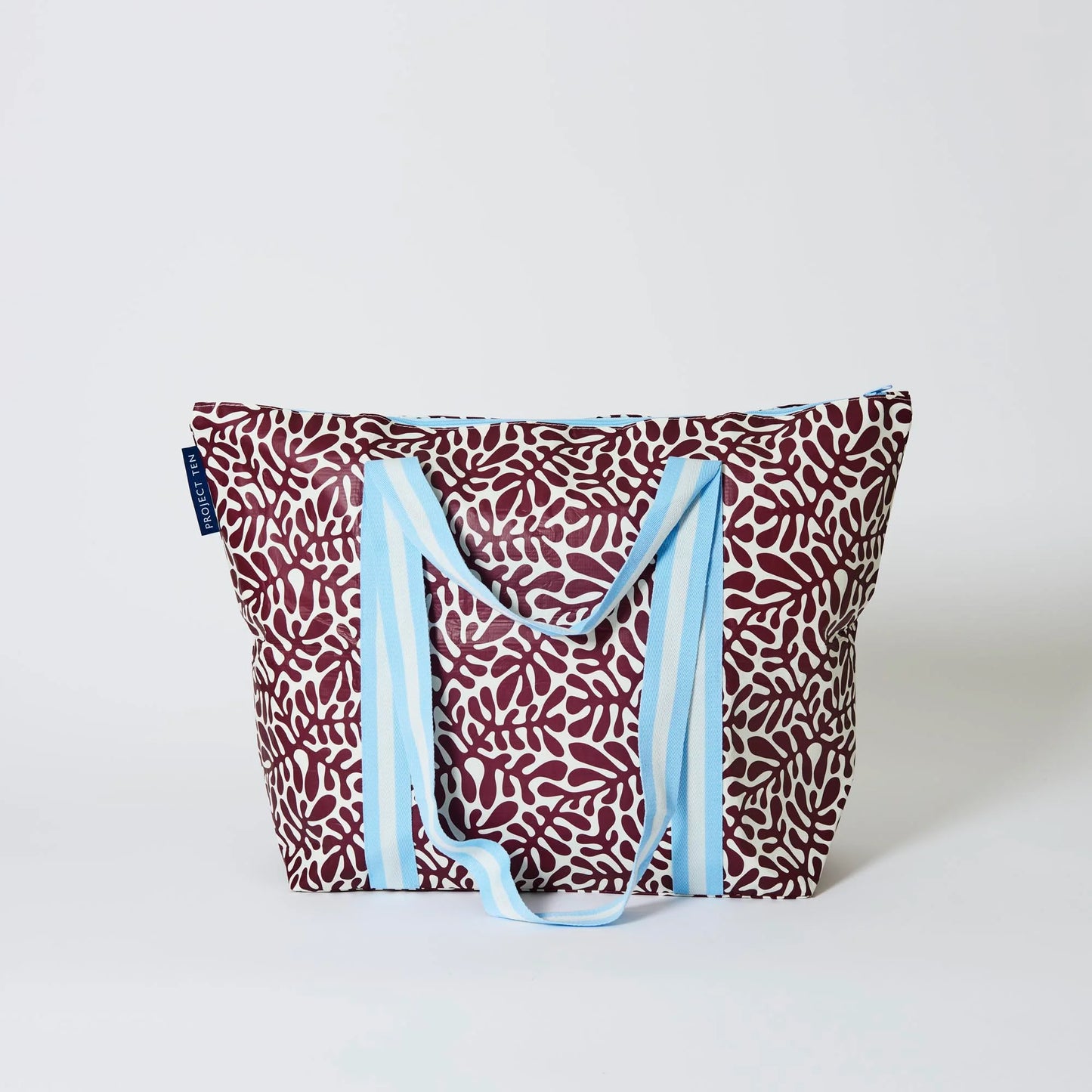 Behind The Trees - Tote bag with a red and white pattern and blue straps on a light gray background - Project Ten - Zip Medium Insulated Tote - Coral