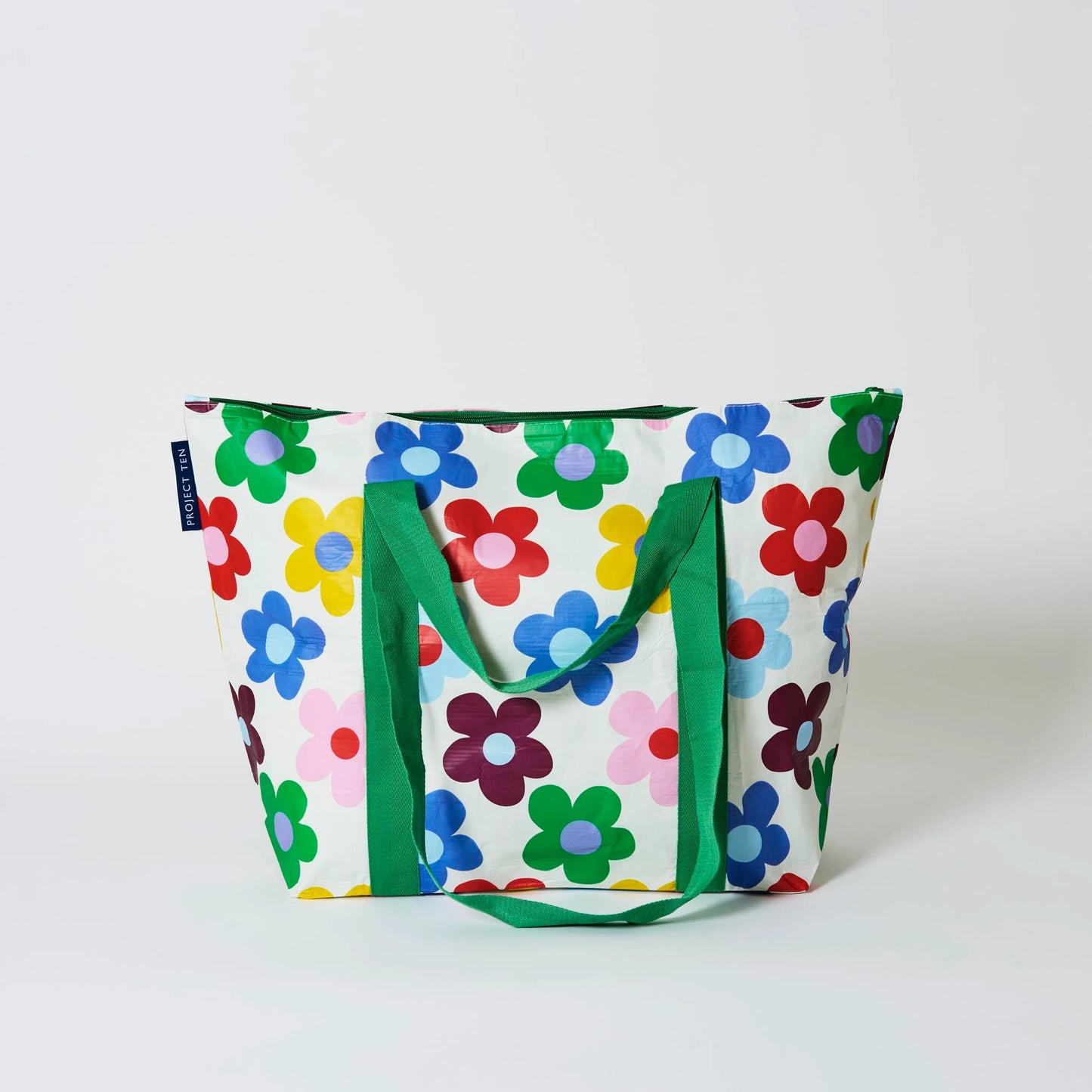 Behind The Trees - Colorful floral-patterned tote bag with green handles on a white background - Project Ten - Zip Medium Insulated Tote - Sunny Floral