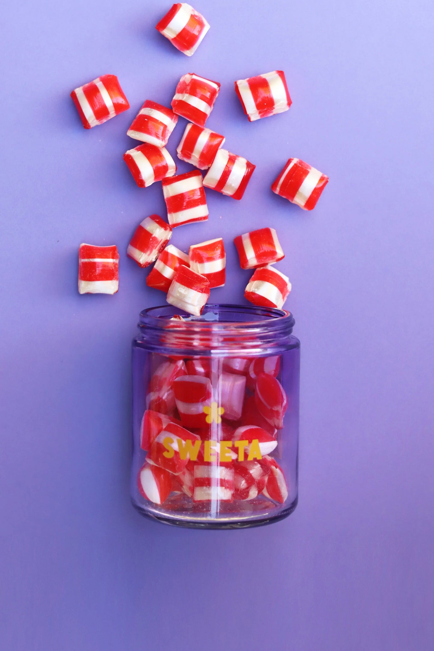 Behind The Trees - Jar of pink and white striped candies with a black lid on a gray surface - Sweeta - Raspberry Humbugs 180g