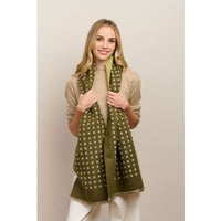 Behind The Trees - Woman wearing a green polka dot scarf against a plain background - Tiger Tree - Petite Fleur Scarf - Moss
