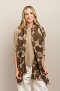 Behind The Trees - Woman wearing a brown patterned scarf and beige sweater on a plain background - Tiger Tree - Tall Poppy Scarf - Coffee