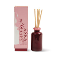 Behind The Trees - Saffron Rose diffuser bottle with pink cap and packaging on a white background - Designworks - Stacked 3.2 FL OZ (94ml) Glass Diffuser w/ Pink Lid and Red Base - Saffron Rose