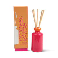 Behind The Trees - Pink diffuser bottle with wooden sticks and orange packaging labeled 'Infrared Mango' on a white background - Designworks - Stacked 3.2 FL OZ (94ml) Glass Diffuser w/ Orange Lid and Hot Pink Base - Infrared Mango