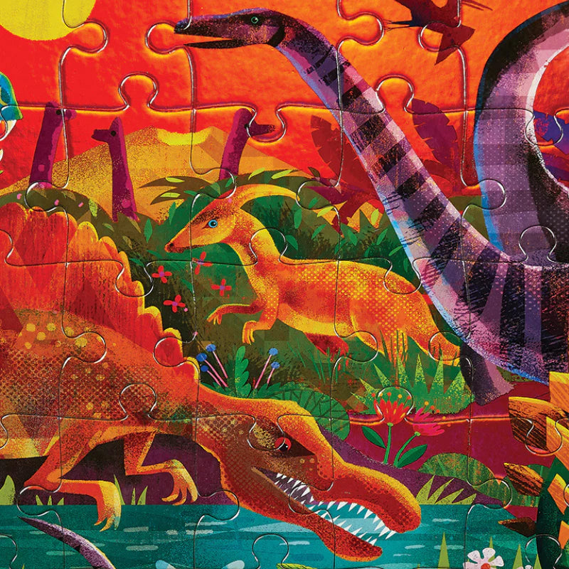 Behind The Trees - Dinosaur-themed puzzle box with colorful illustrations on a white background - Crocodile Creek - Foil Puzzle 60 pc - Dazzling Dinos