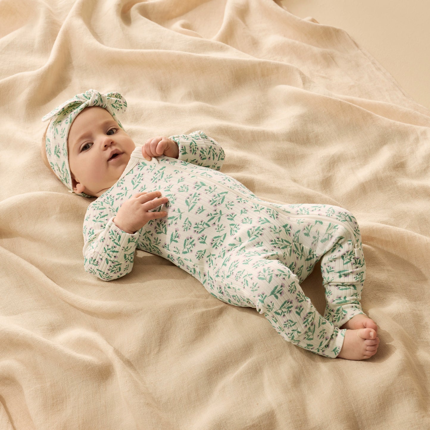 Behind The Trees - Baby onesie with green floral pattern on a white background - Wilson + Frenchy - Organic Zipsuit With Feet - Periwinkle