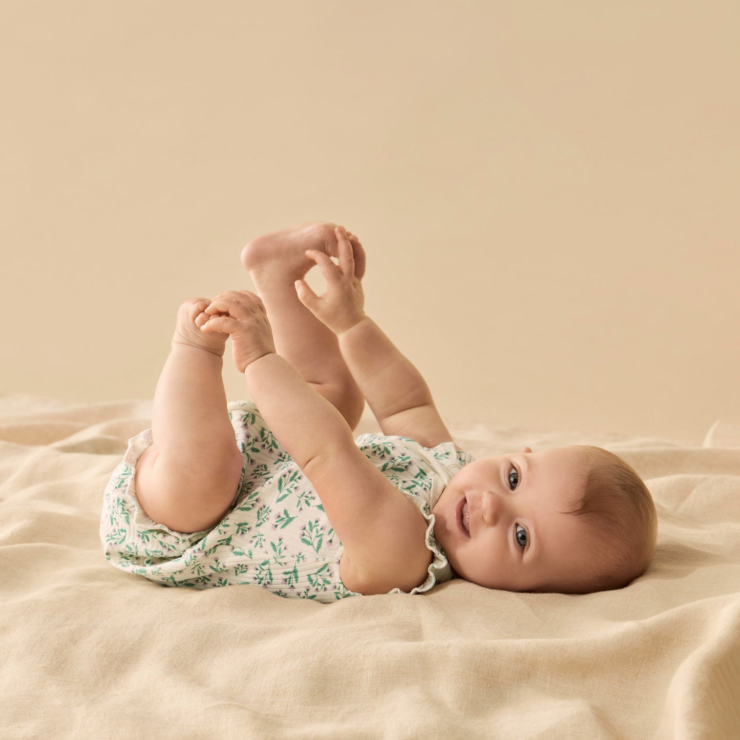 Behind The Trees - Baby romper with green floral pattern on a white background - Wilson + Frenchy - Organic Ruffle Zipsuit - Periwinkle