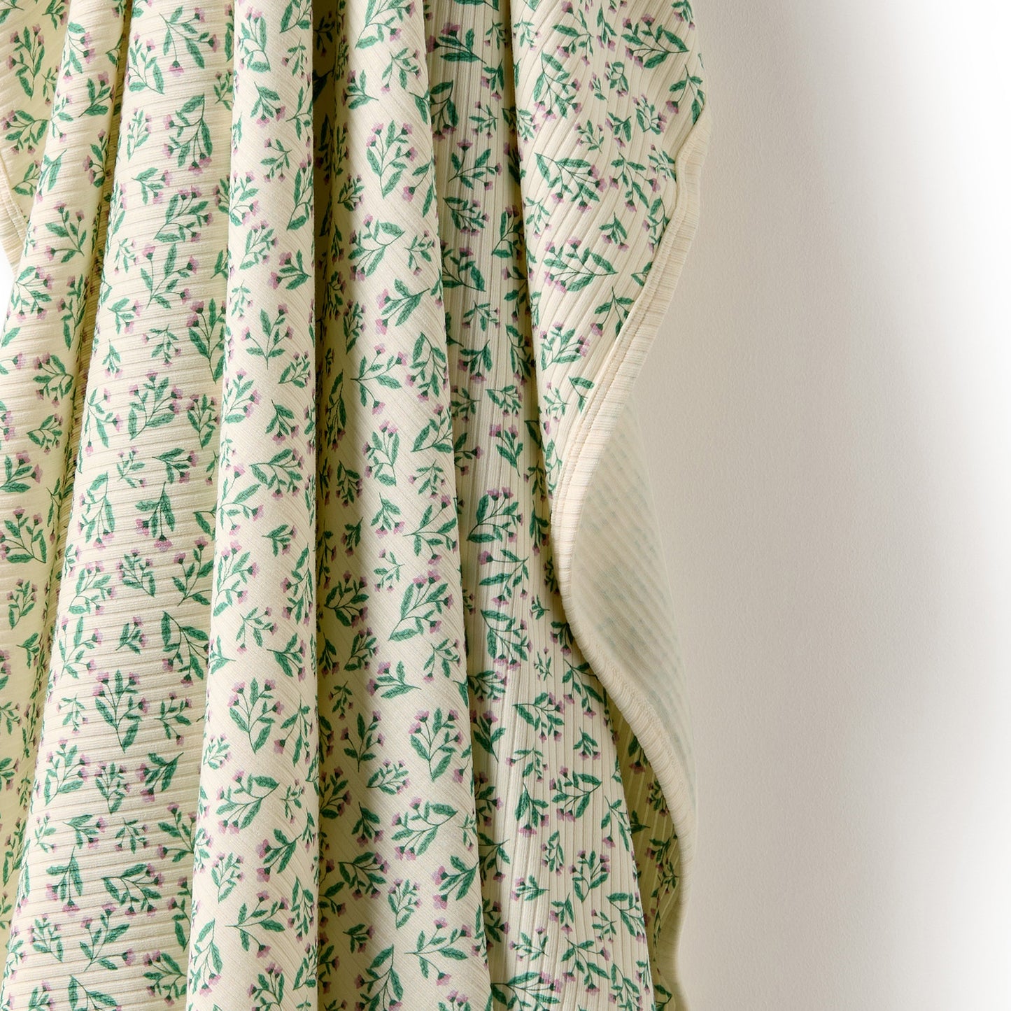 Behind The Trees - Rolled-up fabric with floral pattern on a white background - Wilson + Frenchy - Organic Bunny Rug - Periwinkle