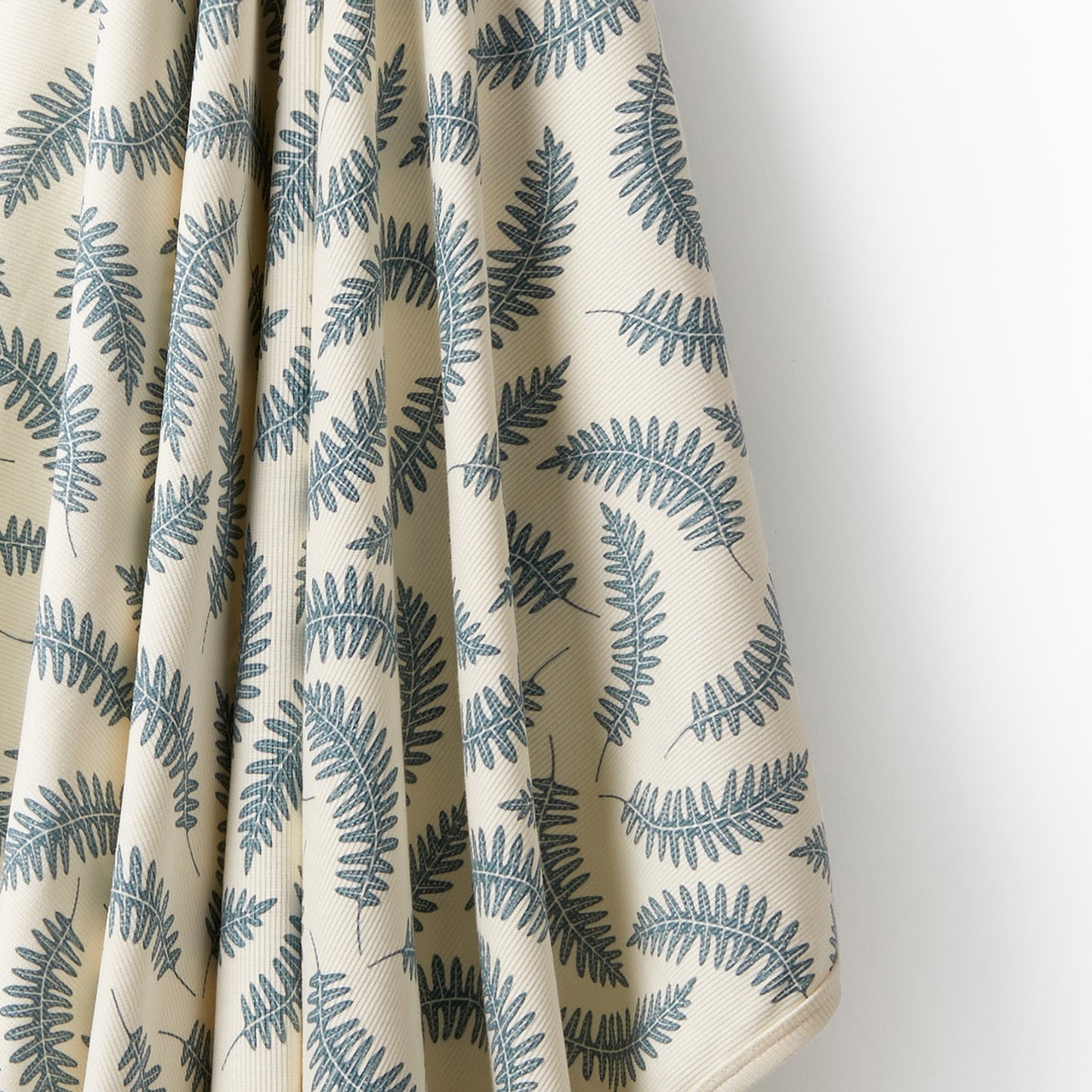 Behind The Trees - Roll-up mat with leaf pattern and 'Waldorf & Friends' branding on a white background - Wilson + Frenchy - Organic Bunny Rug - Little Fronds