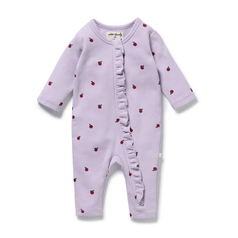 Behind The Trees - Purple baby onesie with red apple pattern on a white background - Wilson + Frenchy - Organic Waffle Ruffle Zipsuit - Berry Plums