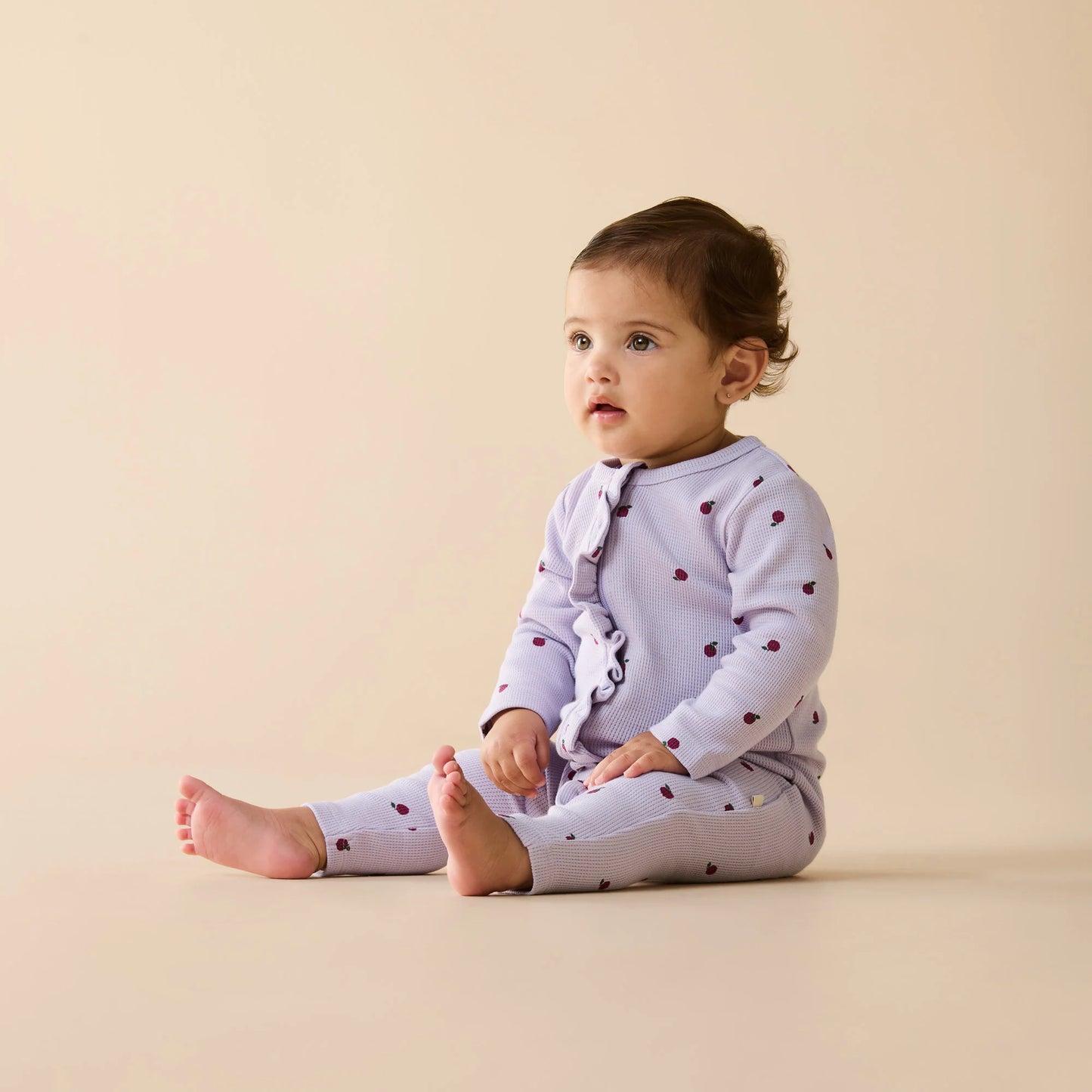 Behind The Trees - Purple baby onesie with red apple pattern on a white background - Wilson + Frenchy - Organic Waffle Ruffle Zipsuit - Berry Plums