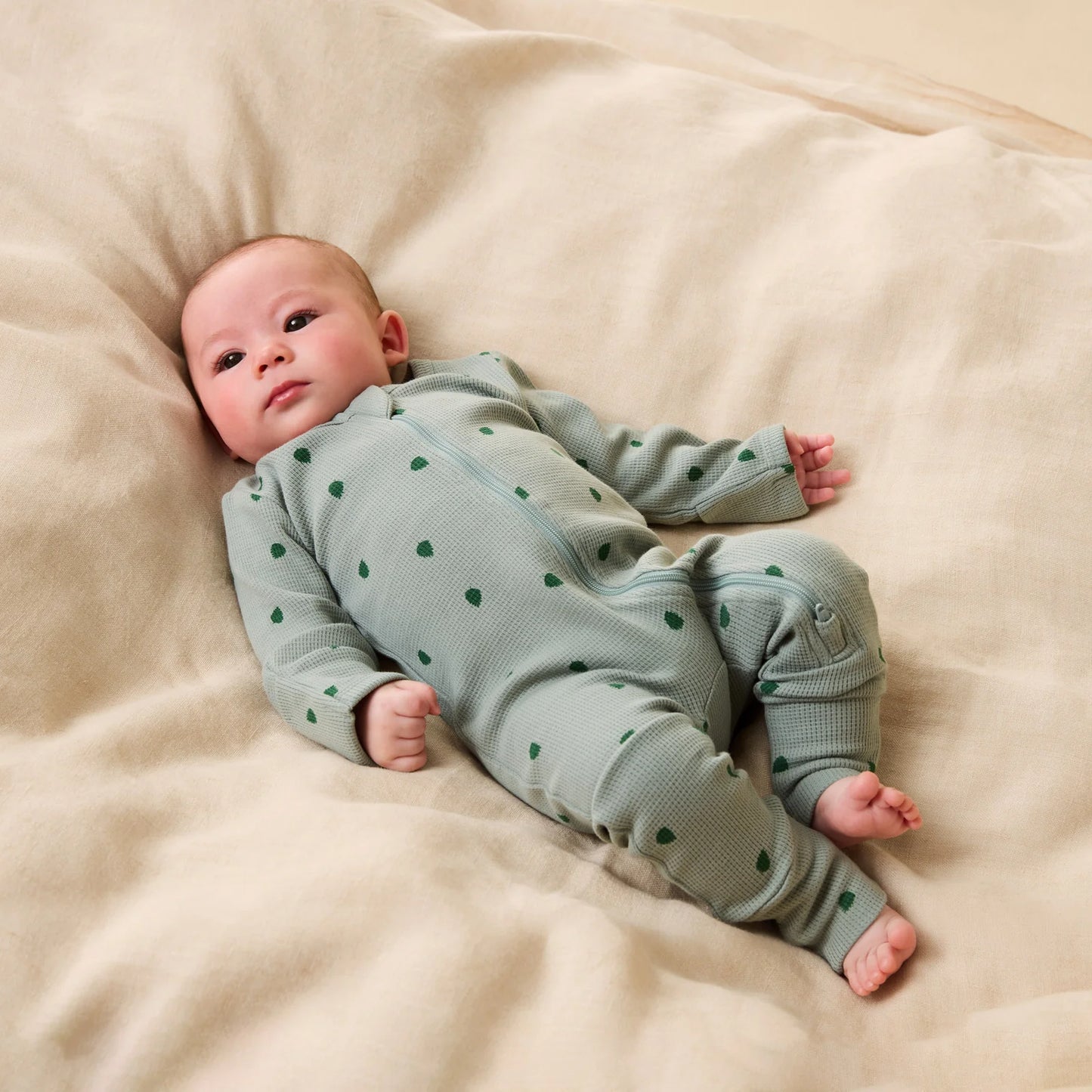 Behind The Trees - Green baby onesie with a subtle pattern on a white background - Wilson + Frenchy - Organic Waffle Zipsuit - Tumbletwig