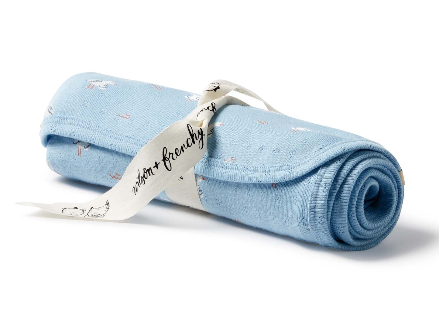 Behind The Trees - Rolled-up light blue blanket with a tag on a white background - Wilson + Frenchy - Organic Pointelle Bunny Rug - Sunny Seagulls