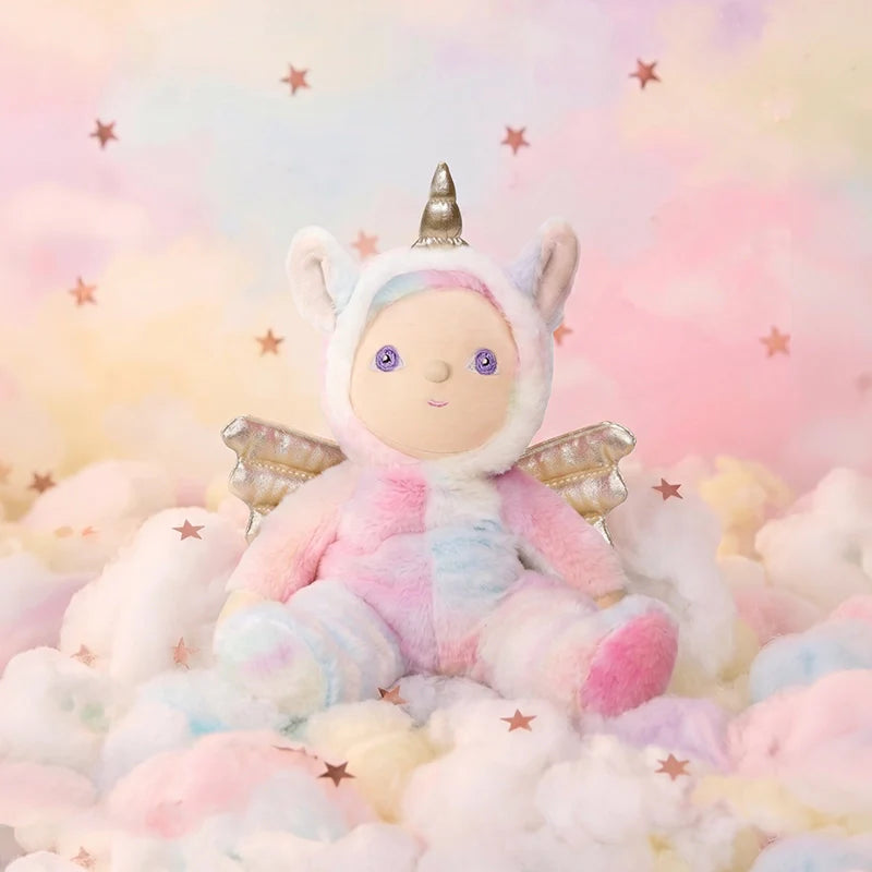Behind The Trees - Stuffed toy in a unicorn costume on a soft, cloud-like surface with a pastel starry background. - Olli Ella - Dinky Dinkum - Yara Unicorn