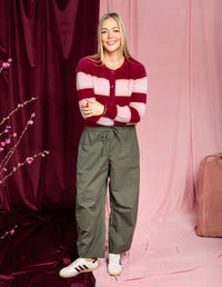Behind The Trees - Woman wearing a pink and red striped sweater with green pants on a gray background - Elm - Anna Ombre Knit Cardigan - Maroon Ombre Stripe